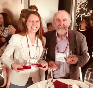 PhD Candidate Elizabeth Drake poses with Dr. Otwin Marenin while holding her awards.