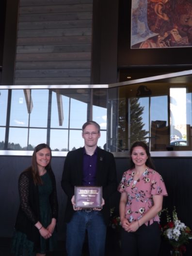 Oliver Bowers, center, holds his award placque, flanked by students Samantha Bill & Emma Smith.