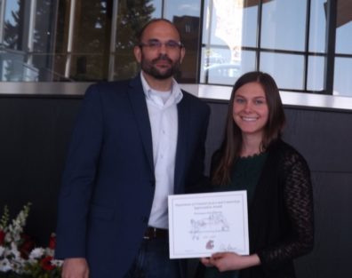 Dr. David Makin stands with Samantha Bill, who is displaying her award certificate..