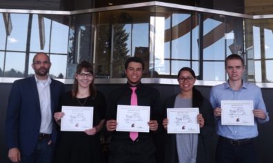 Dr. David Makin stands with students Staci Friede, Jordan Chatman, Sarah Sherrod, & Mantz Wyrick, who are displaying their award certificates..