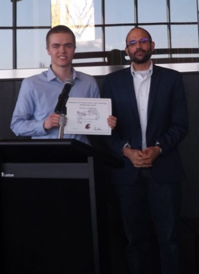 Student Mantz Wyrick holds his award certificate, standing next to Dr. David Makin.