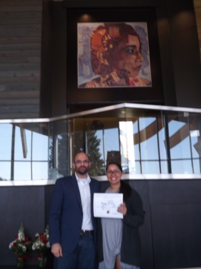 Dr. David Makin stands beside Sarah Sherrod, who is holding her award certificate..
