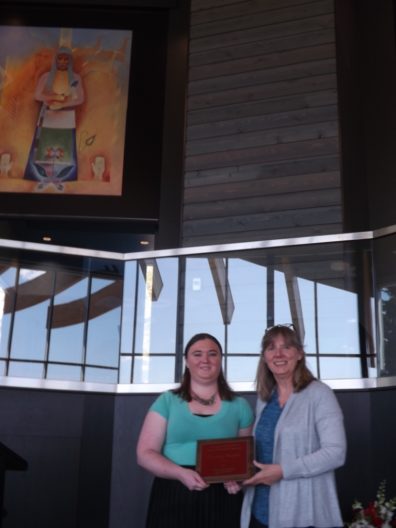 Courtney Bagdon accepts her award placque from Dr. Faith Lutze.