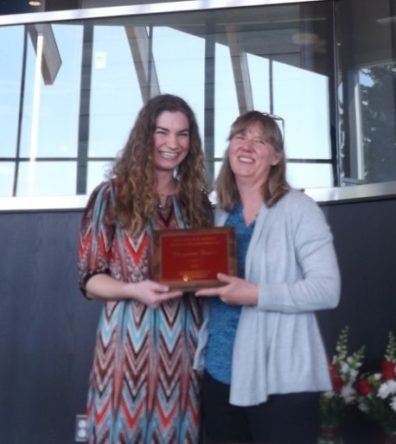 Cheyenne Foster accepts her award placque from Dr. Faith Lutze.