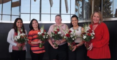 Jackie Baltazar, Sisouvanh Keopanapay, Tina Krauss, Rebeca Orozco, & DeeDee Torgeson stand with floral bouquets of appreciation.