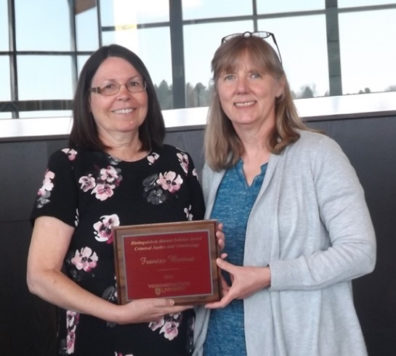 Alumna Frances Bernat receives her award placque from Professor Faith Lutze.
