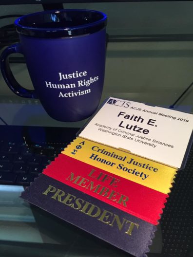Faith's ACJS cup and conference ribbons.