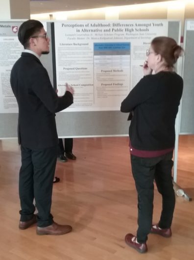 Undergraduate major, Leo Covarrubias conversing with a SURCA judge about his research.