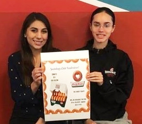 Undergraduate Sociology Club members, Lysandra Perez and Chardonae Odegard fundraising on campus.