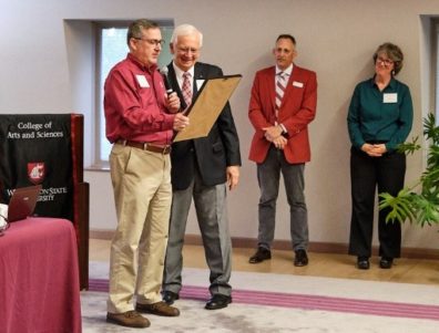 WSU President Kirk Schulz handing a certificate of thanks to Don Dillman for his first 50 years of service. Matthew Jockers and Monica Johnson stand in the background.