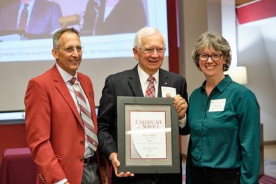 Matthew Jockers, Don Dillman, and Monica Johnson standing together while Don holds the certificate, for 50 years of service at WSU, that he was just awarded.