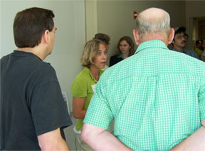 Amy Van Nortwick explaining her results to REU guests