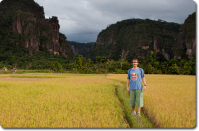 Whitaker standing in a rice field ready for harvest in Indonesia