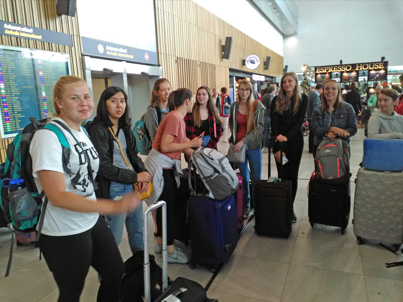 Travel abroad students with luggage at the airport. 