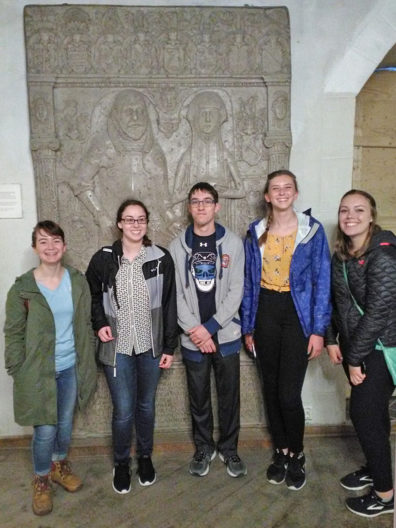 Group standing before the grave stone of the Rosenkrantz's.