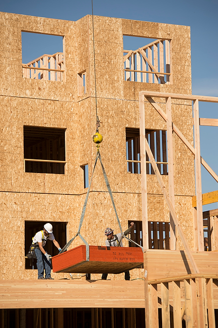 Crane hoists materials to upper levels