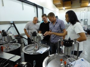 Mark Holst (far left) and Babak Taheri (far right), Cypress Semiconductor Corp., setting up the new wine fermentation system with Washington State University staff Richard Larsen (middle left) and Philip Teller (middle right).