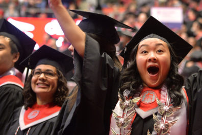 Students dressed in caps and gowns.