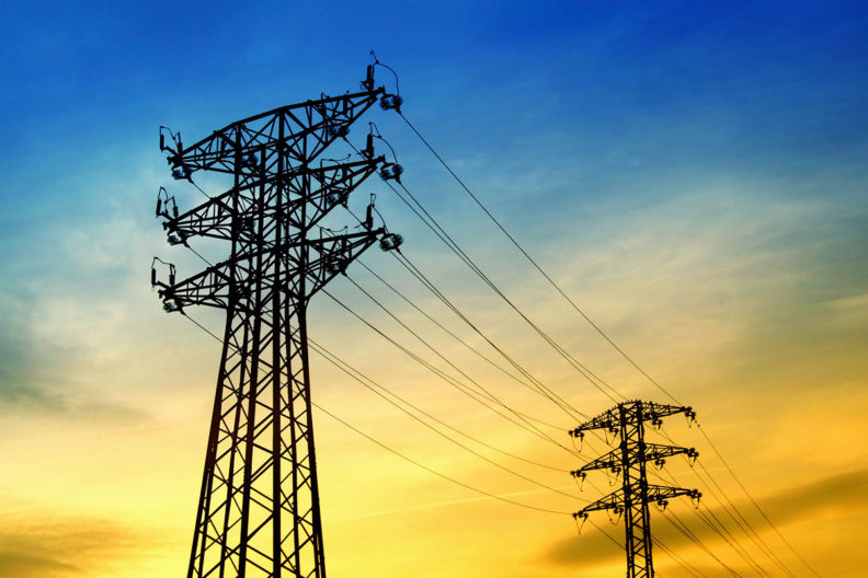 High-voltage power lines at sunset