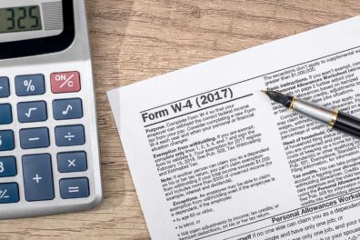 W-4 tax form with pen on desk