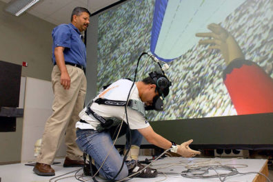 Two people setting a virtual reality device