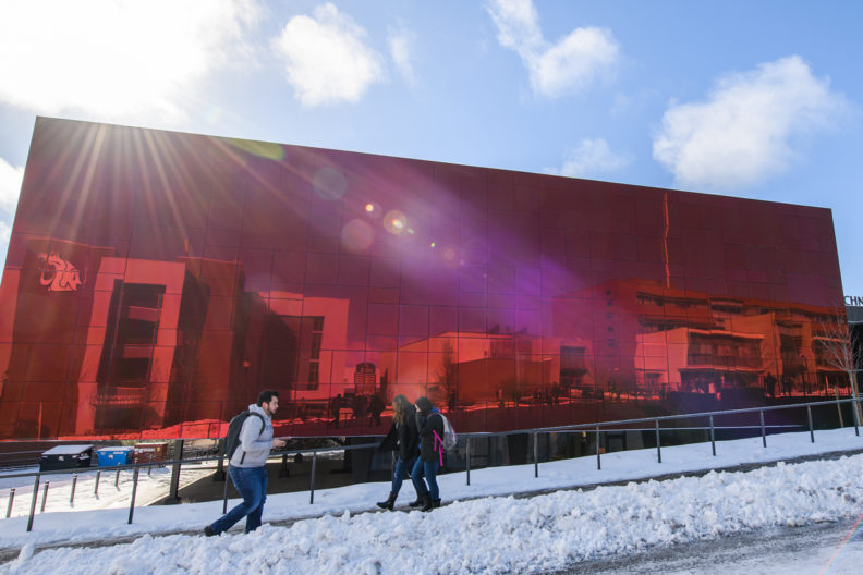 Students walking past the Jordan Schnitzer Museum of Art.