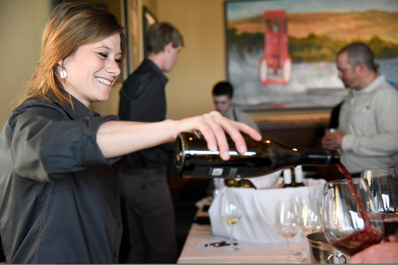 WSU Viticulture & Enology student pours blended wine at 2017 spring dinner.