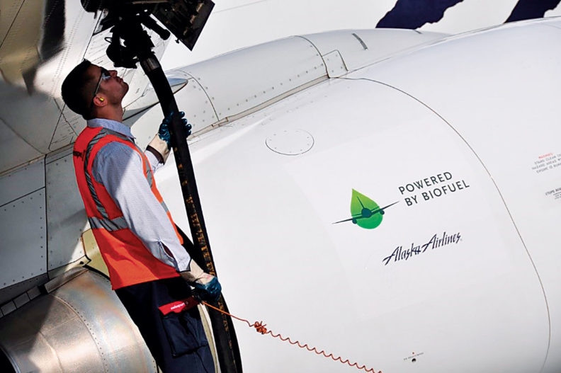 A passenger jet being filled with biofuel.
