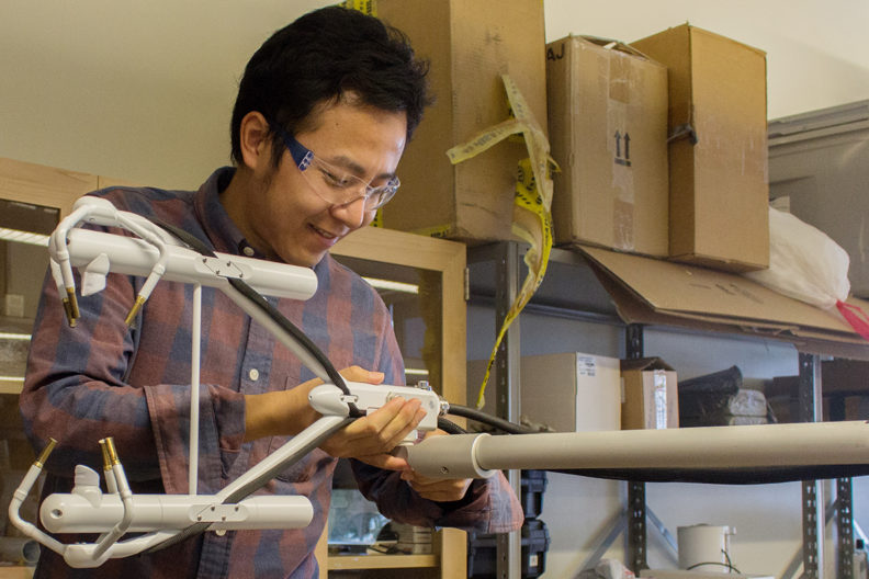 Postdoctoral researcher Zhongming Gao prepares atmospheric measurement instrumentation as part of a new USDA-funded project to study sustainable farming practices in the face of climate change.