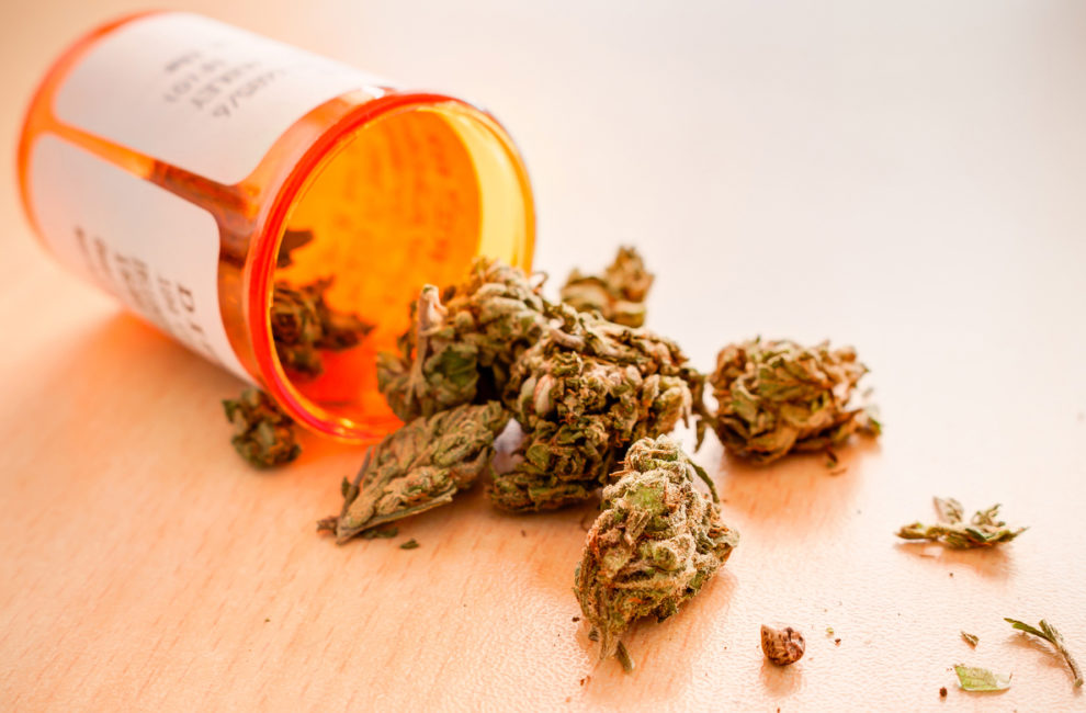 Prescription bottle of medicinal marijuana lays open on a table.