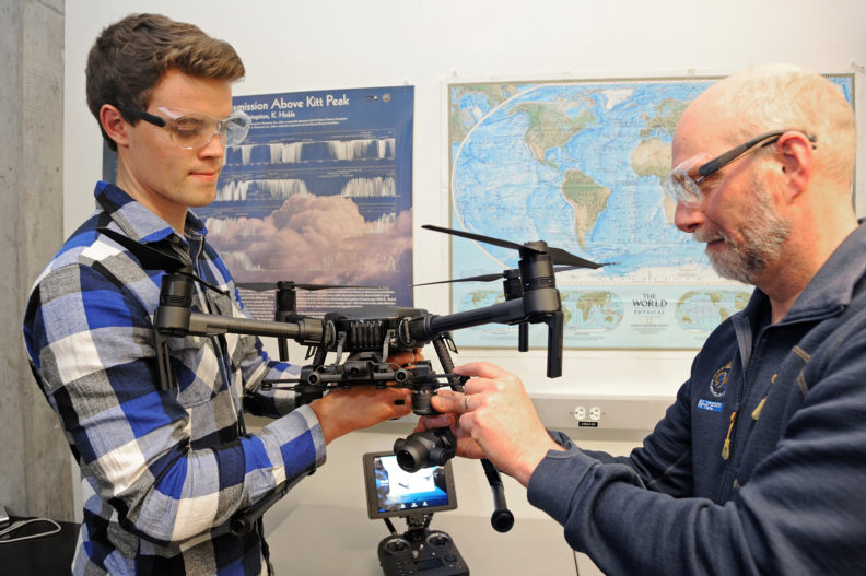 National scholarship recipient Kristian Gubsch examines an aerial drone with Professor Von Walden