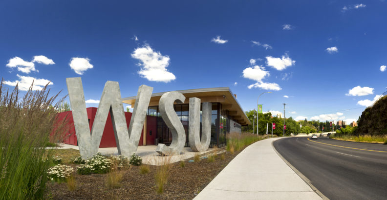 A blue sky with puffy white clouds above the WSU visitor center in Pullman.