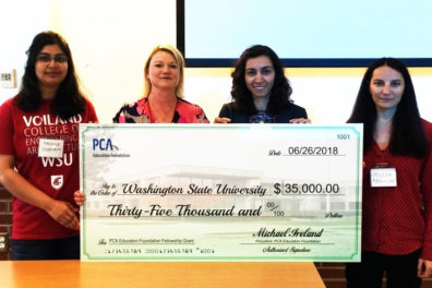 Shehrin, Warner, Nassiri and Rangelov hold a giant $35,000 check.