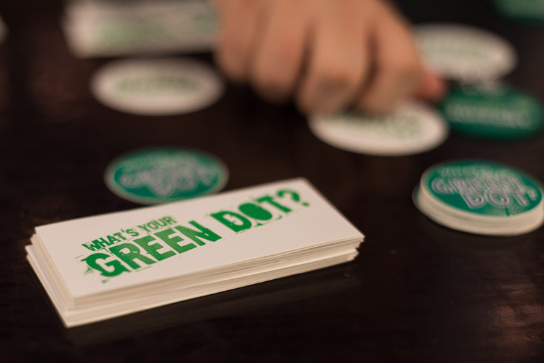 A stack of business cards that read 'What's your Green Dot?'
