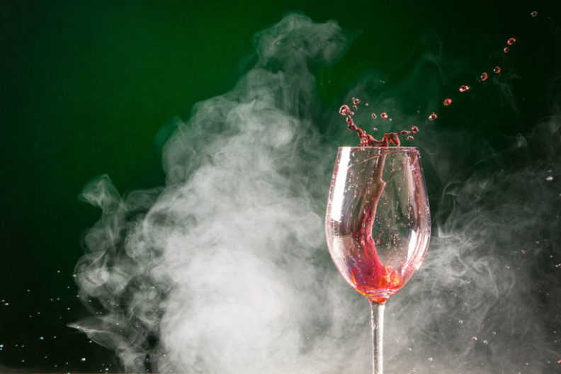 smoke surrounds a glass of wine
