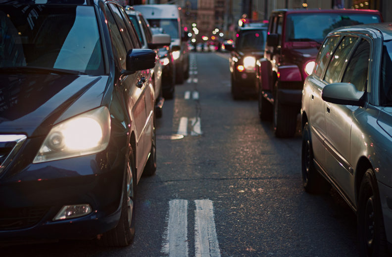 Several cars backed up on a city street.