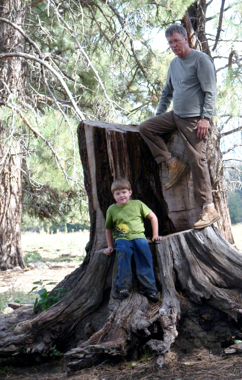 Child and father in forest area.