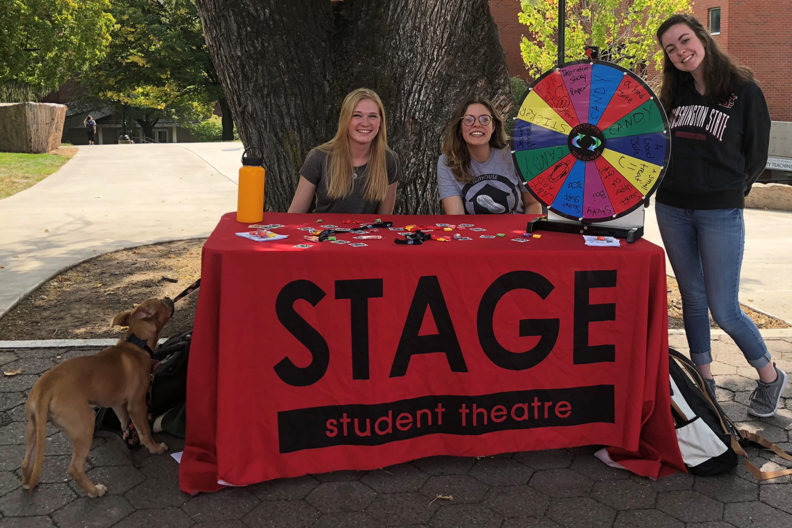 three women students at table near wsu sidewalk