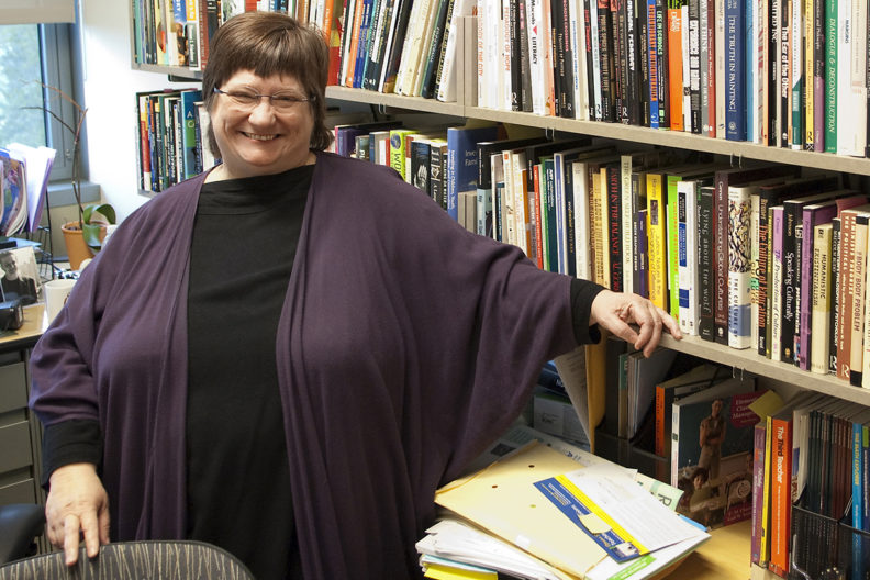 Finley in office surrounded by books.