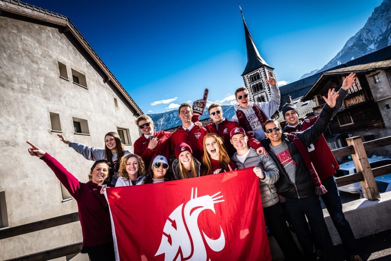 Group of business students holding WSU flag.