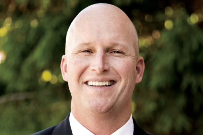 head and shoulders photo of man on campus