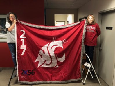 Sharon Macy and Catherine Jasmer hold the Ol' Crimson flag.