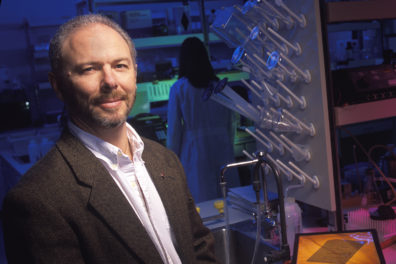 Skinner standing in biological laboratory.