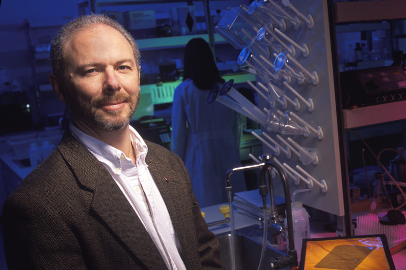 Skinner standing in biological laboratory.