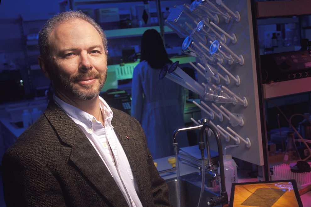 Skinner standing in biological laboratory.