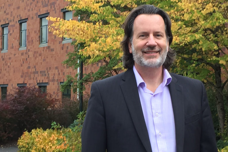 Closeup of Tripp in front of WSU Vancouver building.