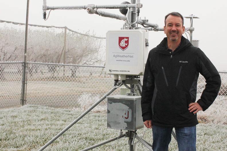 Brown standing in front of AgWeatherNet field equipment.