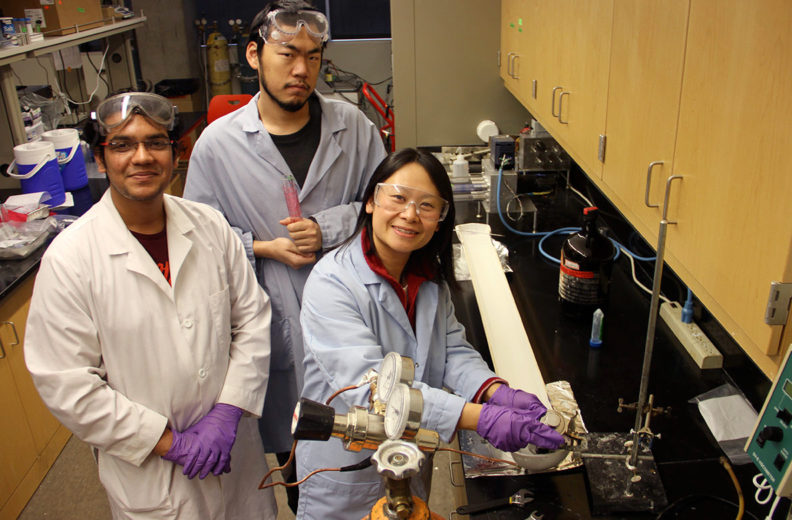 Hang Liu and student researchers in lab demonstrating fabric recycling.