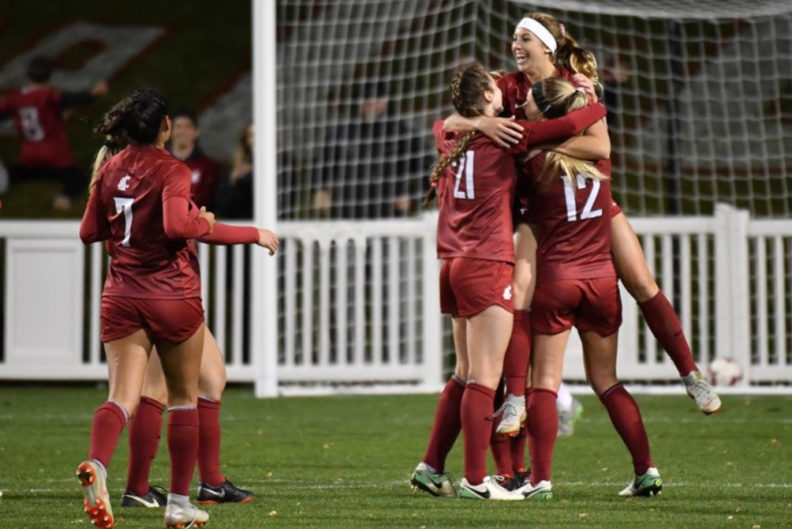 Teammates hold up Weaver in celebration after winning score.