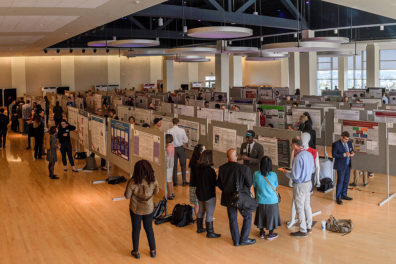 CUB Ballroom full of Showcase participants sharing their work.